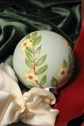 Load image into Gallery viewer, Detail of the hand-painted winter jasmine design on the Frost round ornament