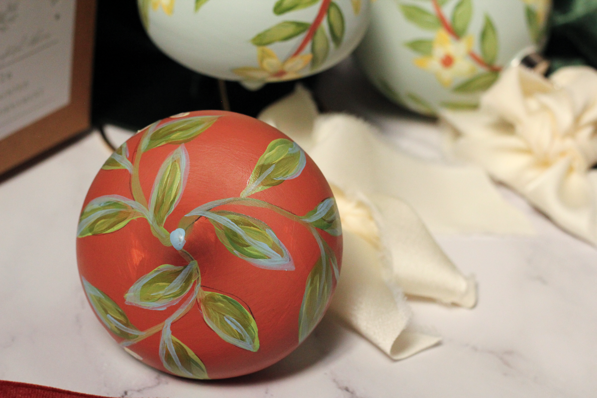 Detail of the hand-painted winter jasmine design on the Cinnamon bulb ornament