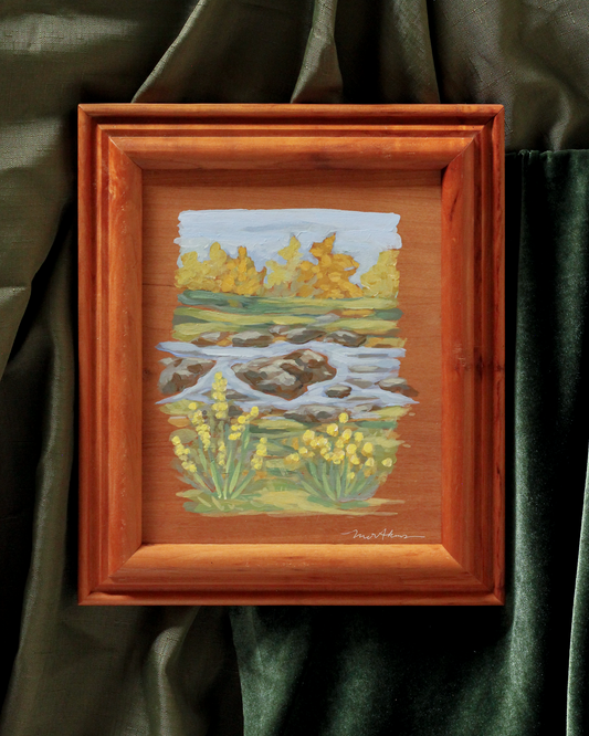custom framed original acrylic painting on panel by meredith raiford akins. Features yellow flowers in the foreground with a rocky stream in the middle of the landscape and fall foliage in the background.