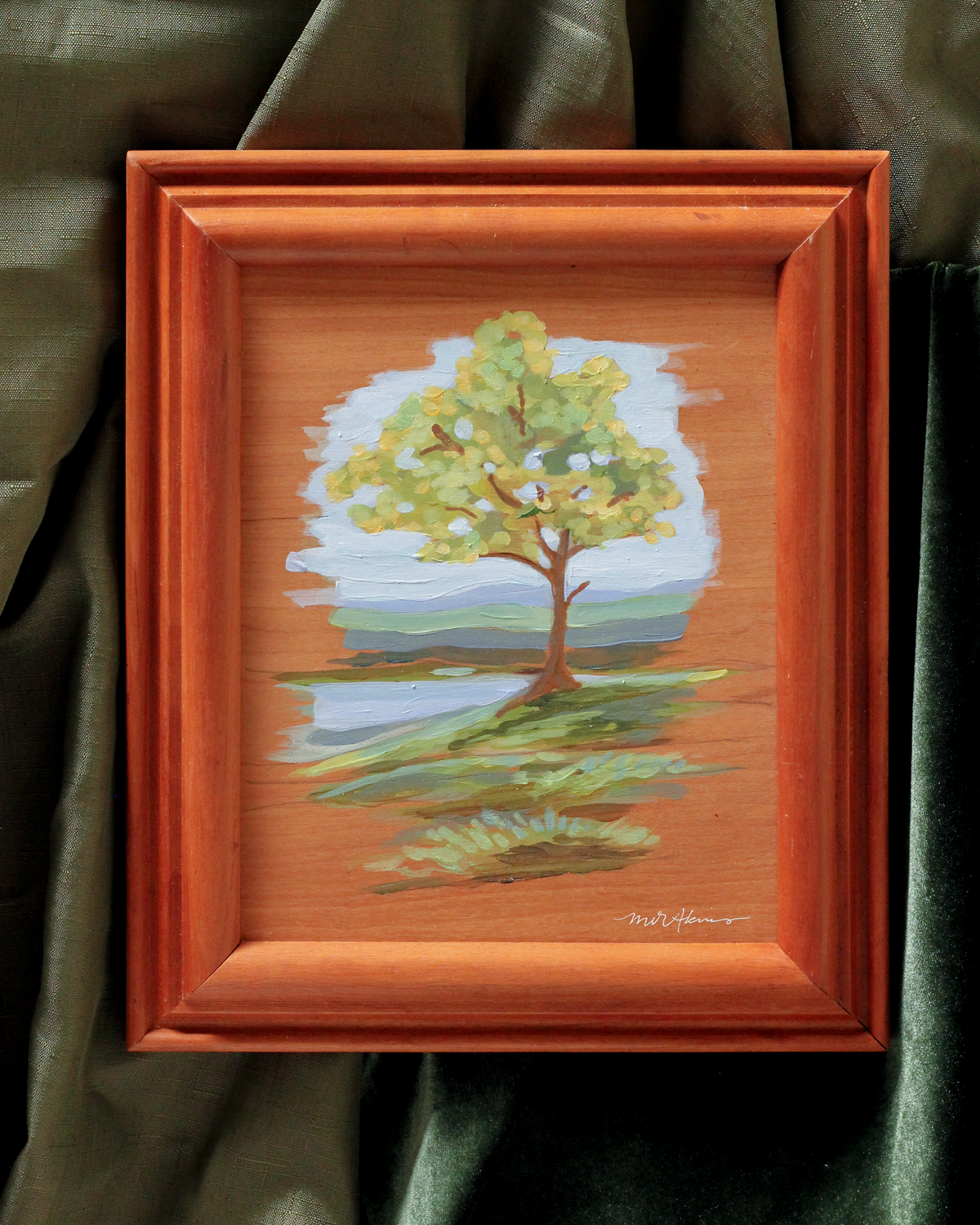 framed original acrylic painting on wood panel of a single tree in front of a pond on a rolling hill with the blue ridge mountains in the background. Painterly original with raw edges by meredith raiford akins