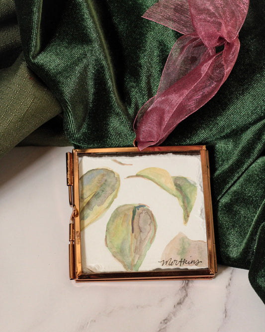 handpainted watercolor ornament of camelia leaves by meredith raiford akins